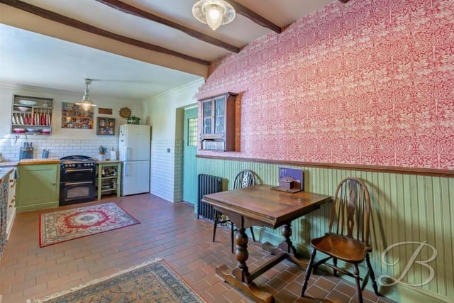 The lovely kitchen has lots of room for a dining table and chairs. The tiled flooring is particularly attractive too.
