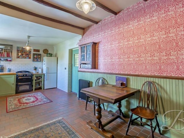 The lovely kitchen has lots of room for a dining table and chairs. The tiled flooring is particularly attractive too.