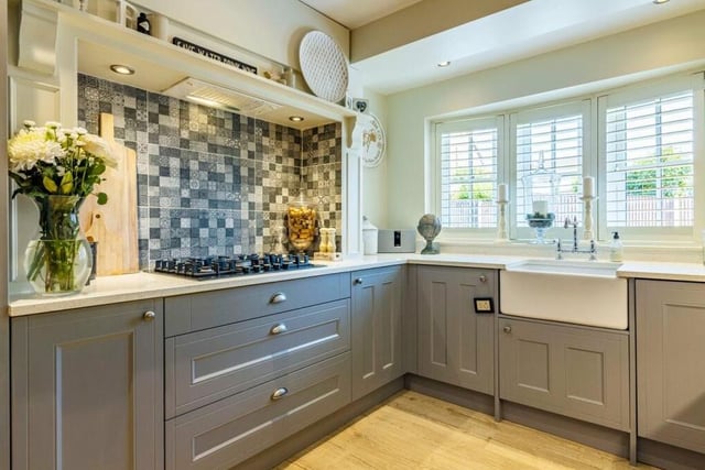 The dining kitchen has a touch of class about it, with a range of matching wall and base units and granite work surfaces incorporating an inset Belfast sink. A double-glazed bay window, with integrated shutter-blinds, overlooks the front of the property.