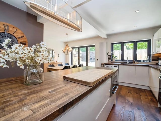 The open plan kitchen diner with integrated appliances such as fridge freezer, dishwasher and wine fridge.