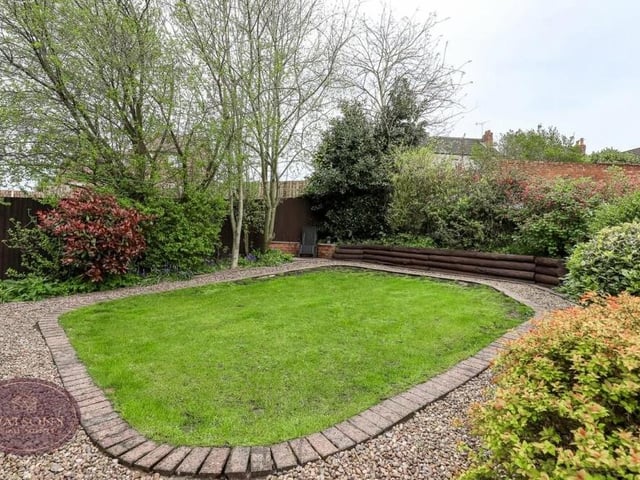 This landscaped, turfed lawn, with gravel borders, is a charming feature of the back garden, particularly during summer.