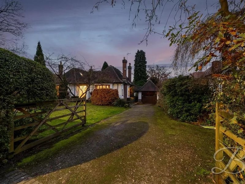 Upon arrival, you'll be welcomed by a gated driveway and a well-maintained front lawn.