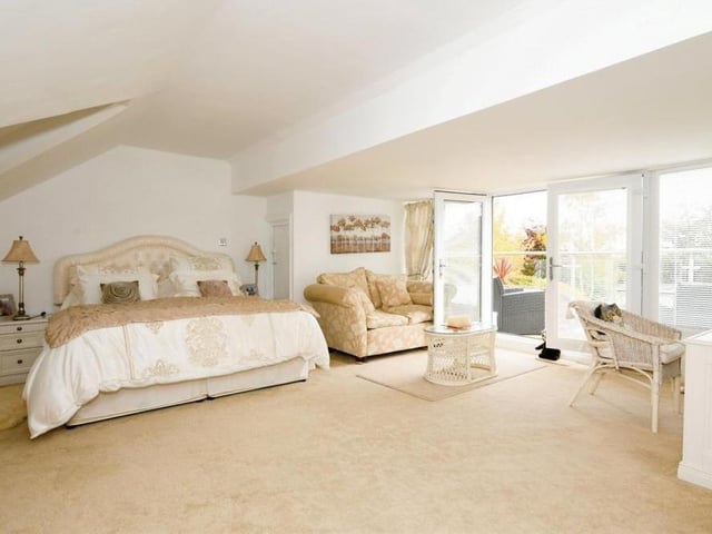 The master bedroom sits on the first floor. A marvellous open-plan space, it has an en suite bathroom, dressing area and balcony overlooking the back garden.