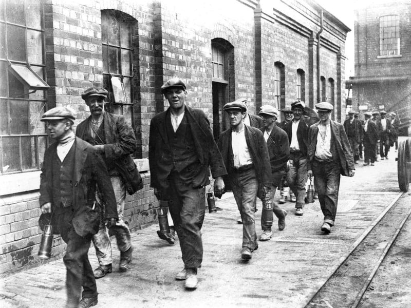 Miners from the colliery at Crown Farm near Mansfield on their way home from work on 1st August 1926.