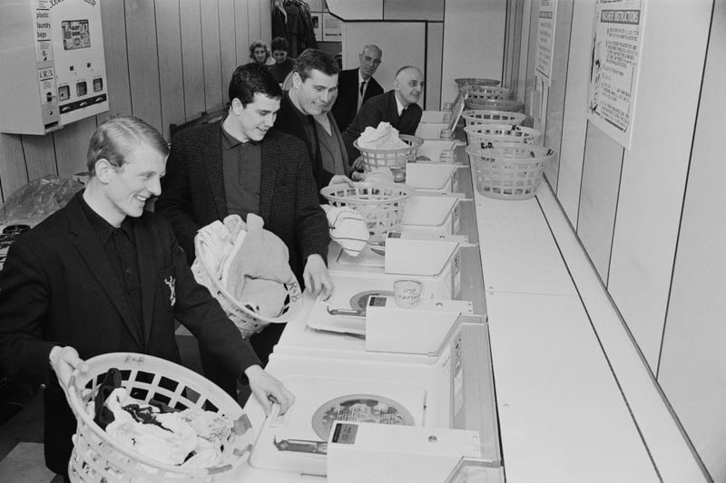 Nottingham Forest players and manager Johnny Carey are pictured doing their laundry at a launderette on 14th January 1967.