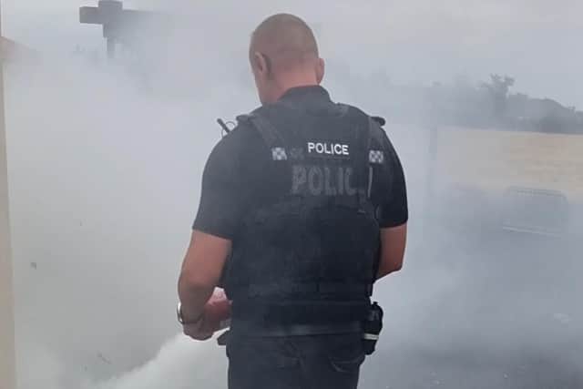 A police officer tackles a fire in Forest Town.
