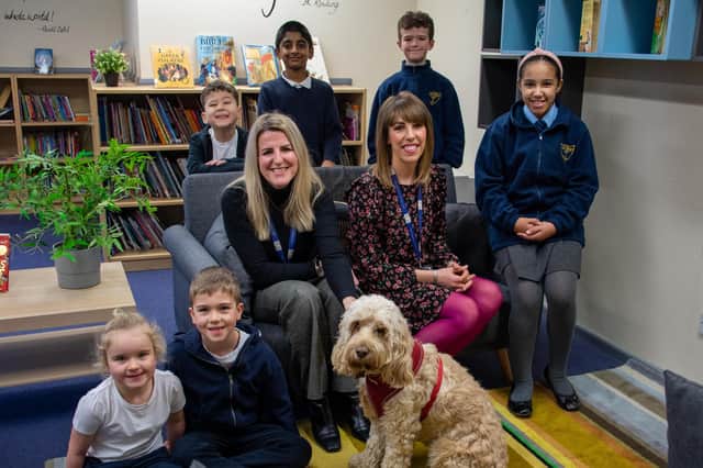 Staff, children and the school dog, Maggie, celebrate St Mary Magdalene Primary School's Ofsted report. Head teacher Samantha Robinson (centre right) is pictured with the deputy head, Sarah Pearson (stroking the dog). PHOTO BY: Louise Brimble