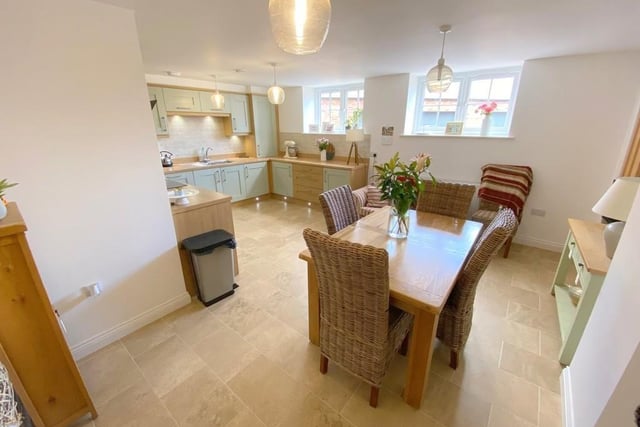 The dining area from a different angle, which shows how it is attached to the kitchen. The whole open-plan format is spacious and stylish.