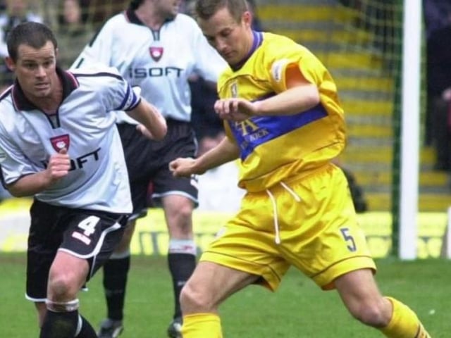 Tom Curtis is shadowed by Mitch Ward.