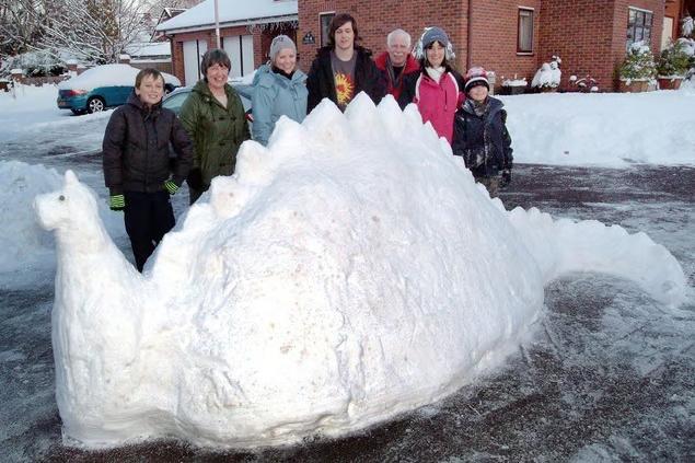 Creators of this snow stegasaurus at Woodview Gardens, Forest Town, show off their hard work.