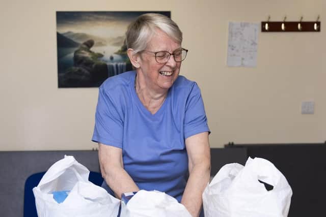 Filling the bags full of food ready for distribution