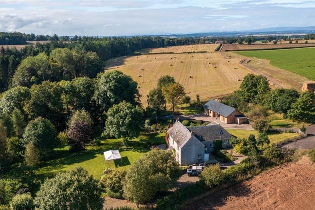 Aerial view of property and land.