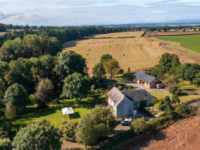 Aerial view of property and land.