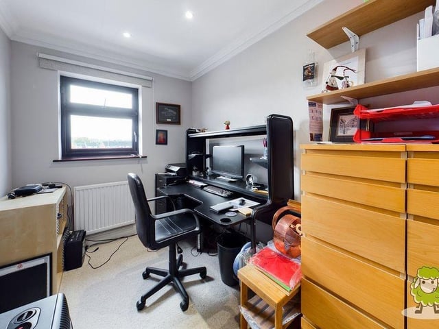 The other two bedrooms are currently being used for other things. One has doubled up as a craft room, while this single bedroom has been converted into office space.