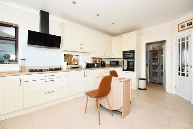 The first of the main rooms we look at is the high-standard kitchen, recently fitted by respected Kirkby company Colemans. It boasts integrated appliances and a host of units and cupboards for storage. A door leads out to the back garden.