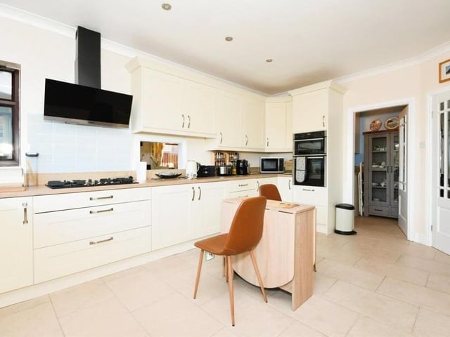 The first of the main rooms we look at is the high-standard kitchen, recently fitted by respected Kirkby company Colemans. It boasts integrated appliances and a host of units and cupboards for storage. A door leads out to the back garden.