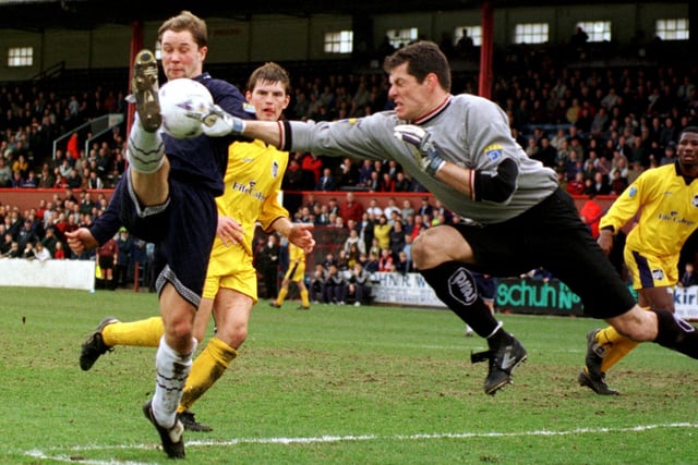 It's March 1998 and Raith keeper Guido Van De Kamp punches clear as his side win 1-0 thanks to an Andy Walker penalty.