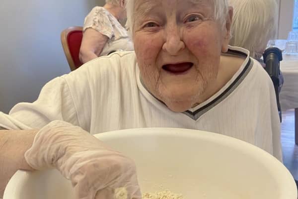 Resident Glenda enjoying making the Matzah Bread