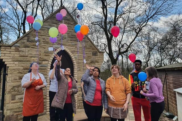 Staff at Wren Hall releasing balloons on We Will Remember Day.