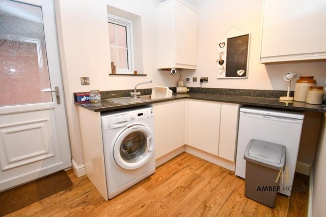 Just off the kitchen is this handy utility room, which includes space and plumbing for a washing machine.