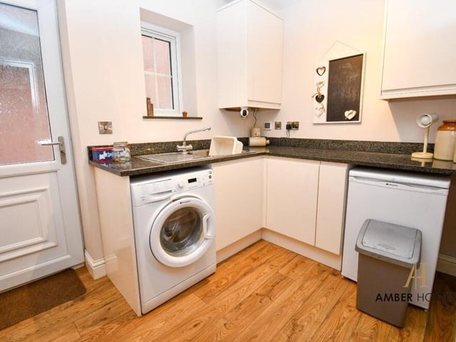 Just off the kitchen is this handy utility room, which includes space and plumbing for a washing machine.