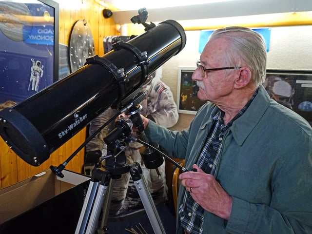 David Collins, founder member with one of the donated loan telescopes.