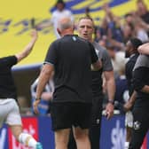 Darrell Clarke hugs Stags boss Nigel Clough at the final whistle (right)