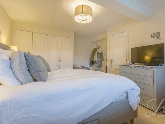 This second photo of the master bedroom shows that it boasts its own fitted wardrobes.