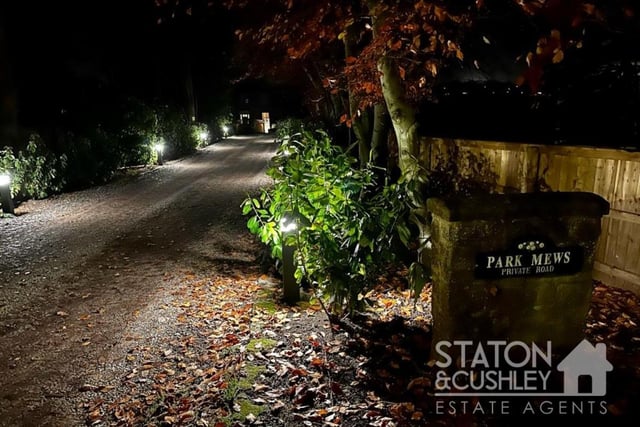 The beautifully lit, private lane that leads to the Park Mews homes.