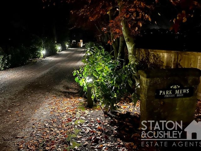 The beautifully lit, private lane that leads to the Park Mews homes.