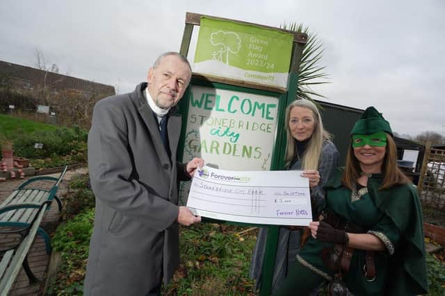 Peter Armitage(L), Nina Dauban(M) and Robina Hood(R) celebrate the £5,000 grant to Stonebridge City Farm.