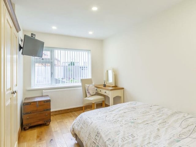 A second look at the third bedroom, which has oak flooring and a window facing the back garden. It is bright and relaxing, and there is space for a desk or dressing table.
