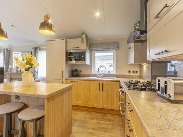 The kitchen includes an attractive range of wall, base and drawer units, as well as wall cabinets.