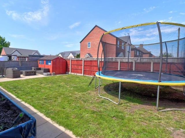As we say farewell to the Appleton Road house, let's take a quick peek at the back garden, which is mainly laid to lawn but also features an attractive patio area.