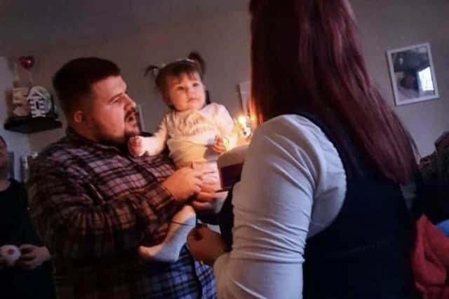 Daniel Hind pictured with his family before losing nine stone.