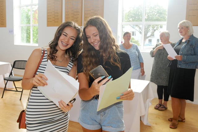 Pictured is: (l-r) Mattie Webb-Pratt (16) and Issy Hall (16) pose for a selfie after collecting their gcse results at Portsmouth High School in Southsea. Picture: Sarah Standing (200820-2966)
