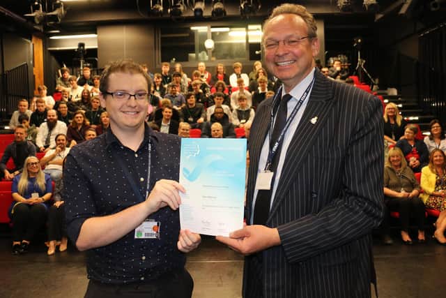 Digital teacher Tommy Mannix (left) receives his highly commended certificate from principal Andrew Cropley.