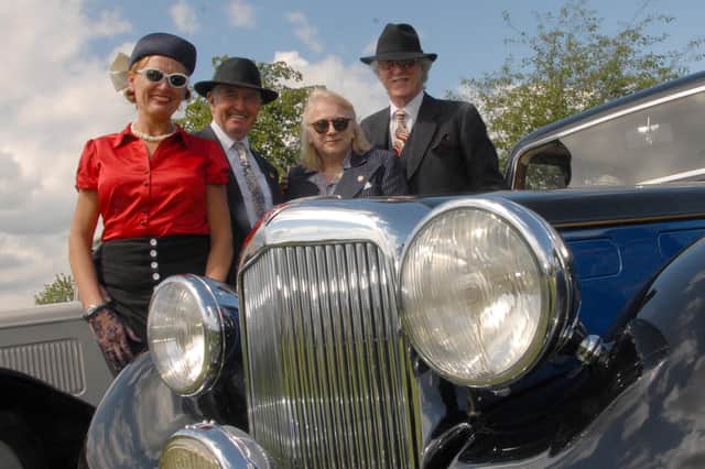 A scene from the last Party In The Park in Kirkby two years ago as fancy-dress fashionistas pose for the camera alongside a vintage car.