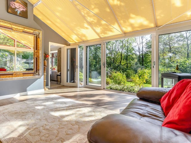 The conservatory includes sliding patio doors that lead out to the beautiful gardens at The Hermitage property.