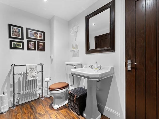 Featuring double glazed frosted window to the side aspect, shower with floor and wall tiling.