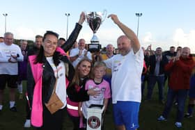 Emma and Lee Wilson hold aloft the Evie Wilson Memorial Trophy