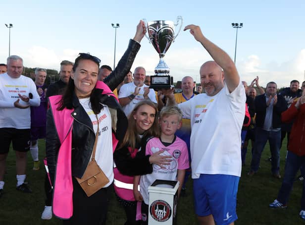 Emma and Lee Wilson hold aloft the Evie Wilson Memorial Trophy