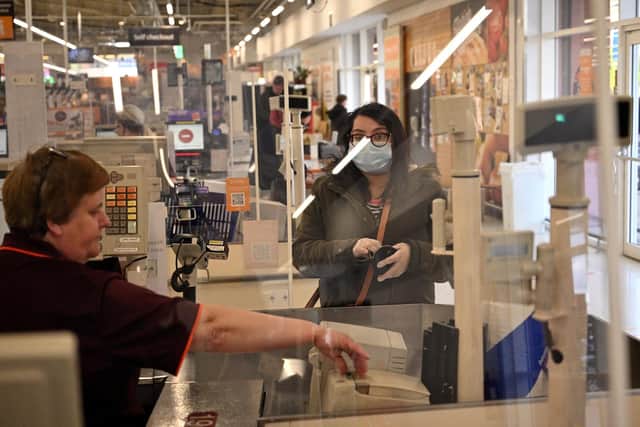 A woman wearing PPE (personal protective equipment) (Photo by Oli SCARFF / AFP) (Photo by OLI SCARFF/AFP via Getty Images)