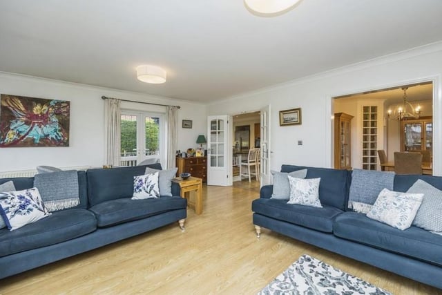 Although the bungalow is cosy, it also has an open-plan feel. For instance, the lounge opens seamlessly into the kitchen and dining room, as you can see here. It is bright thanks to two windows to the rear, one of which is a bay.
