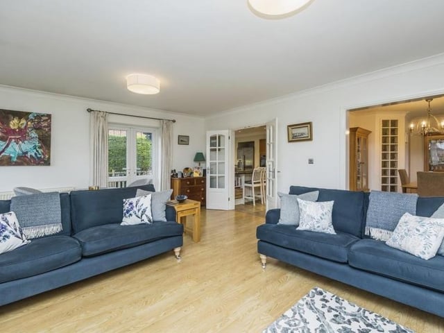 Although the bungalow is cosy, it also has an open-plan feel. For instance, the lounge opens seamlessly into the kitchen and dining room, as you can see here. It is bright thanks to two windows to the rear, one of which is a bay.