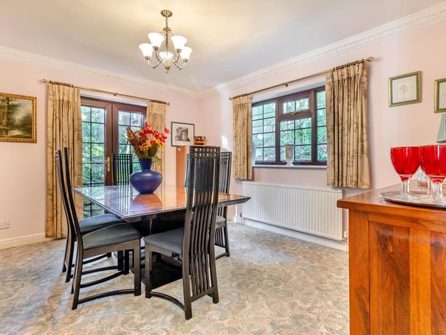 Next stop on our tour of Four Oaks is the charming dining room, which has a patio door that leads out to the gardens at the side and rear of the house.