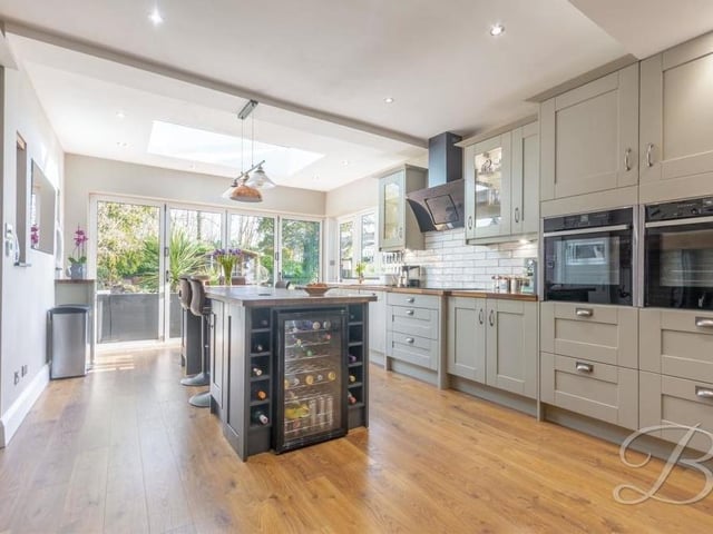 The contemporary kitchen/diner is a real showstopper, especially with its layout and bi-folding doors that bring the outside in. The fitted shaker-style cabinets and units, with complementary work surfaces, are so attractive.