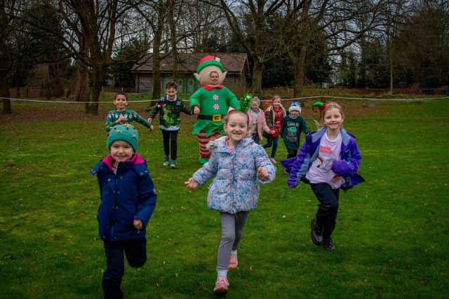 Head Teacher, Jennifer Bailey, dressed as an Elf,  with children of St Mary’s C of E Primary School.