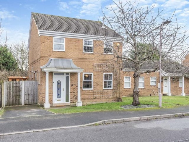 The last image in our gallery returns to the front of the house and underlines its kerb appeal. The front garden is laid to lawn, next to a driveway and a gate that gives access to the back.