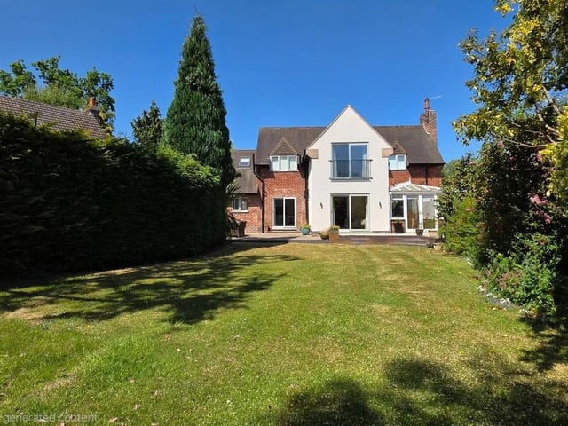 The south-facing rear garden boasts an extensive and elegant patio area offering plenty of space for garden furniture. The garden is laid to lawn with far-reaching views to the end, the garden is planted with mature shrubs which provide a stunning natural backdrop. Looking back up at the house from the bottom of the garden you are met with the sight of the attractive façade of the rear of the house in its tranquil setting.